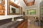 The master bathroom has granite counters, a bath and walk-in shower